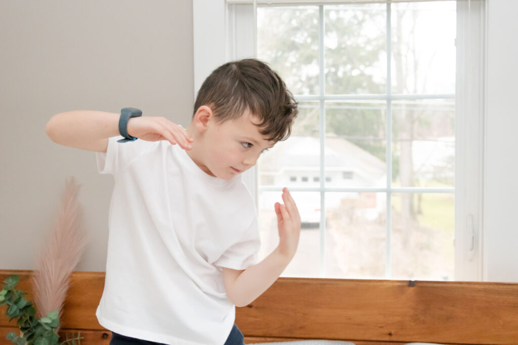 young boy pretending to be a ninja.