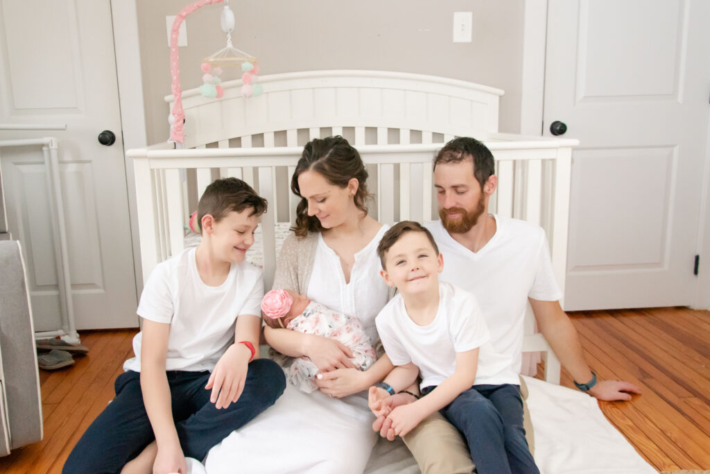 Family in front of crib.