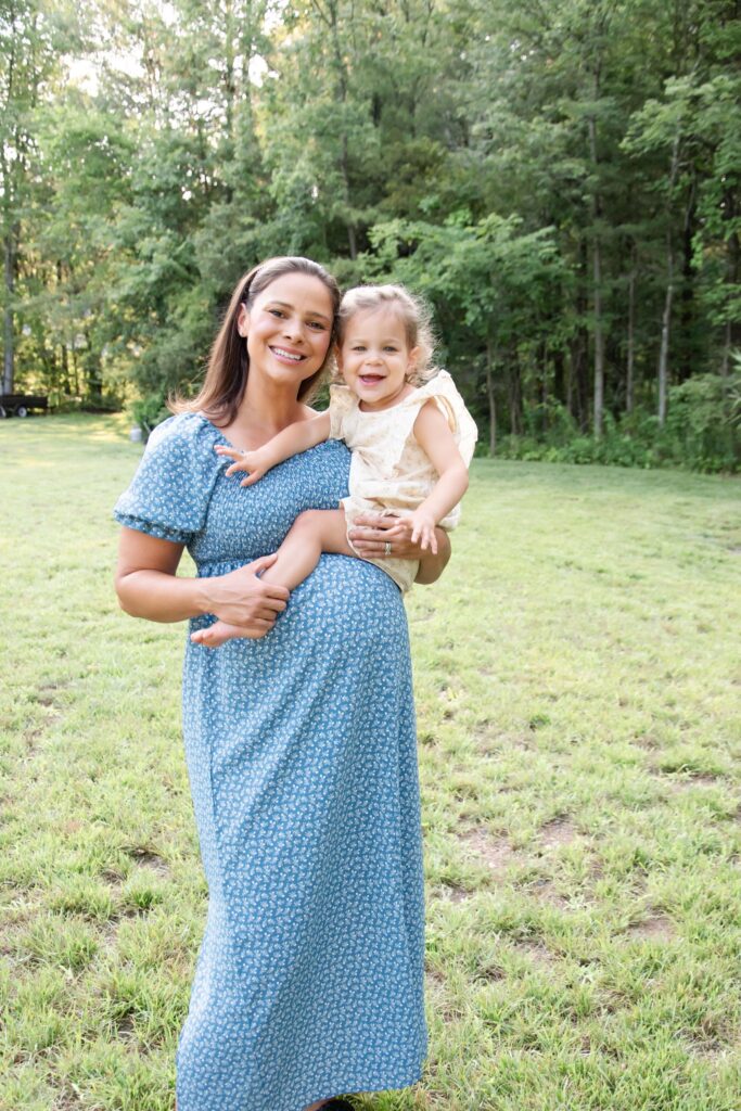 Mom and daughter. Mom is in a blue dress and daughter is in a yellow dress.