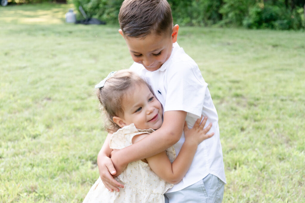 Brother and sister hugging.