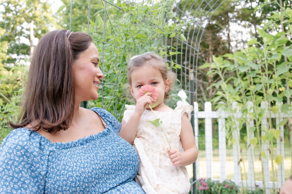 Mom and daughter with pink flower.