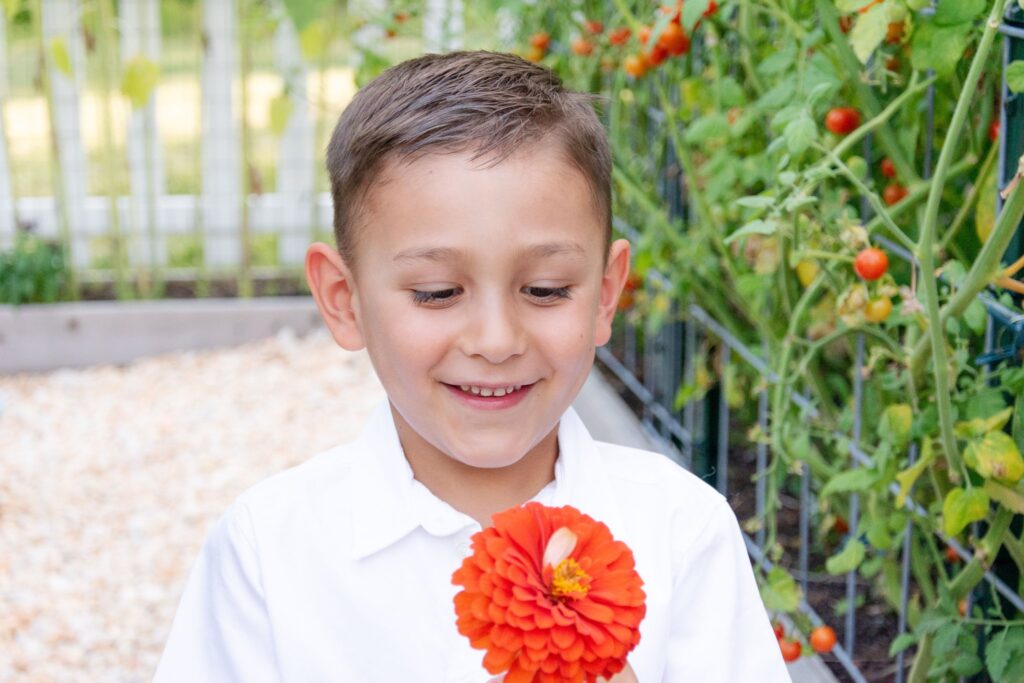 boy with an orange flower.