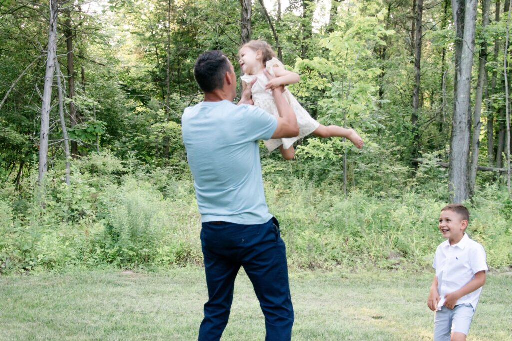 Dad playing with his children.