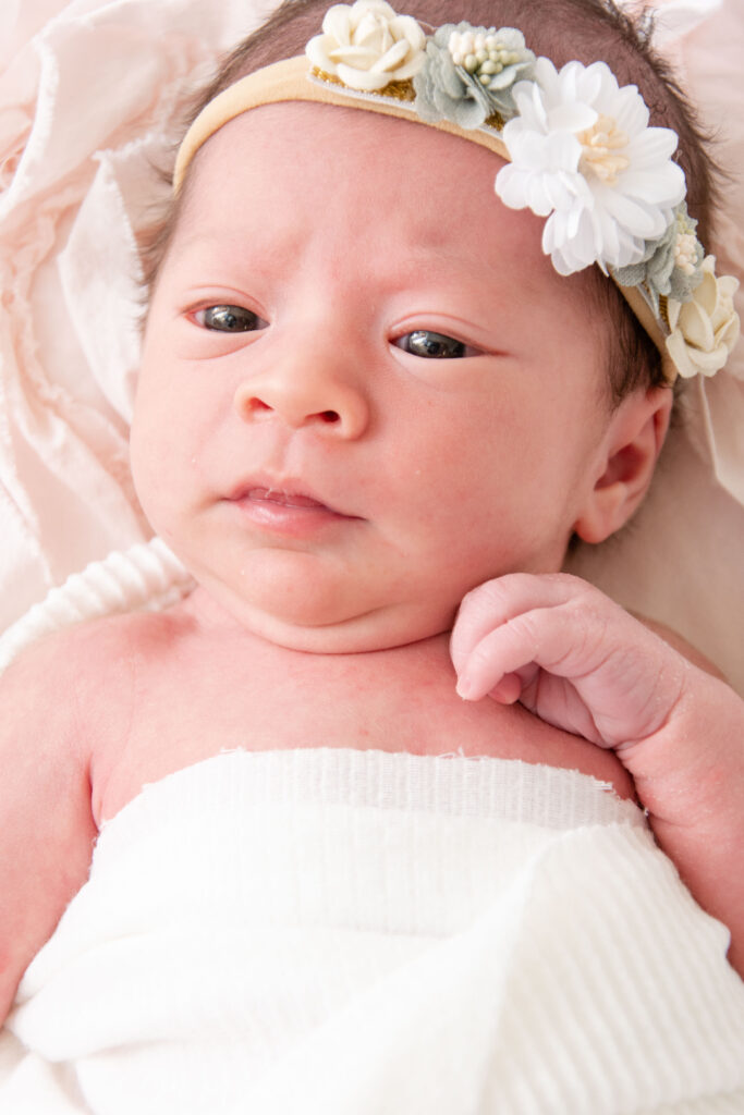 Liltle baby with flower headband.