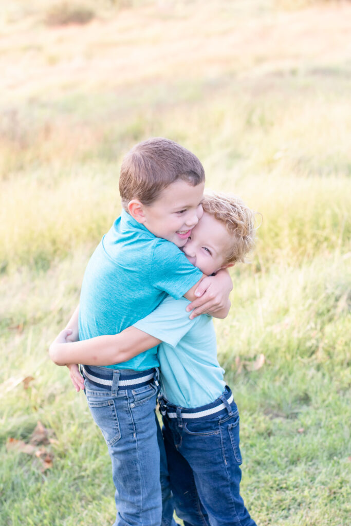 Two brothers hugging. A light and bright image