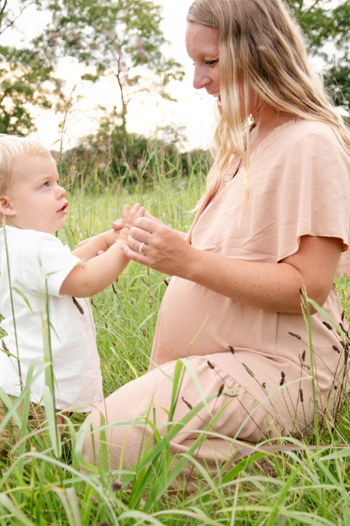 Maternity mom playing with a toddler.