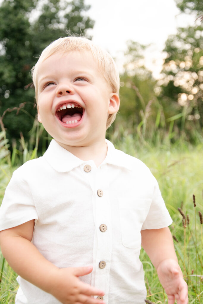 Little boy laughing. A light and bright image.