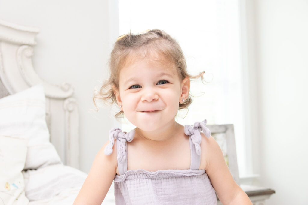 Little girl in a purple dress. Newborn and maternity session.