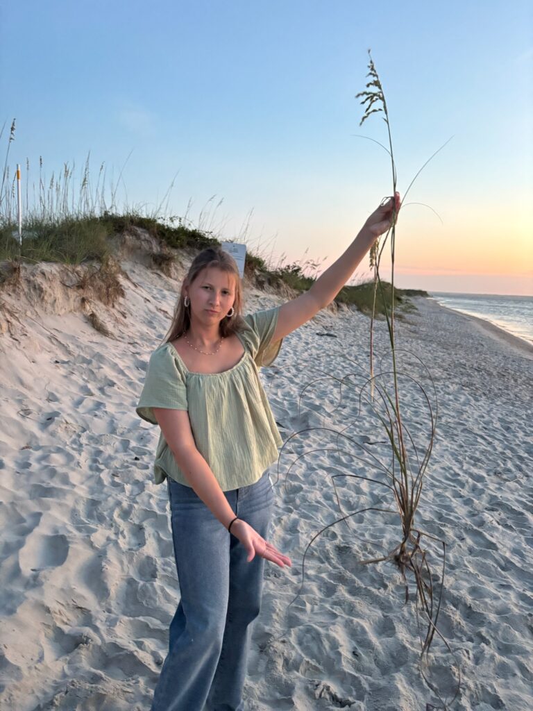 Lizzy from Lizzy Grace photography behind the scenes brand photography holding a weed.