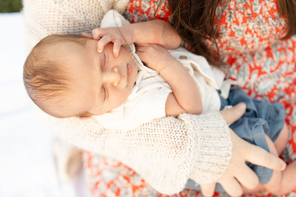 Newborn baby in moms arms.