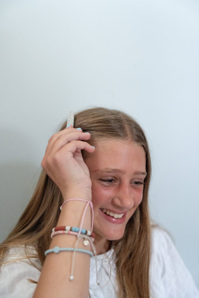 branding portfolio shoot girl putting a clip in her hair.