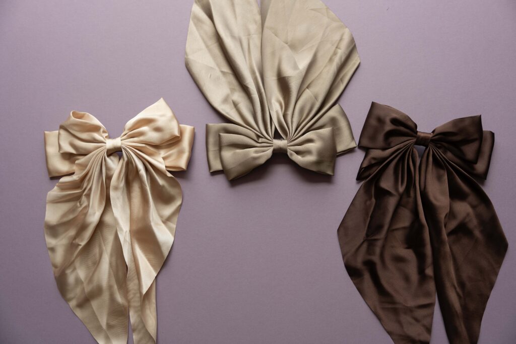 Three silk hair bows all different shades of brown. True to life brand photography.