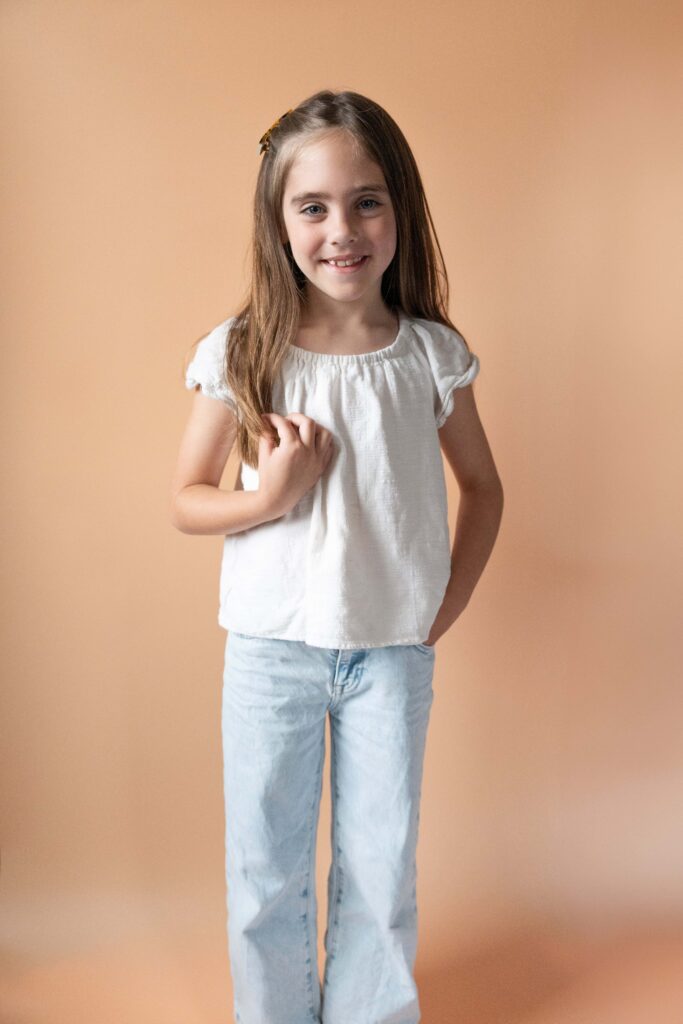 Young girl posing looking at camera standing. 