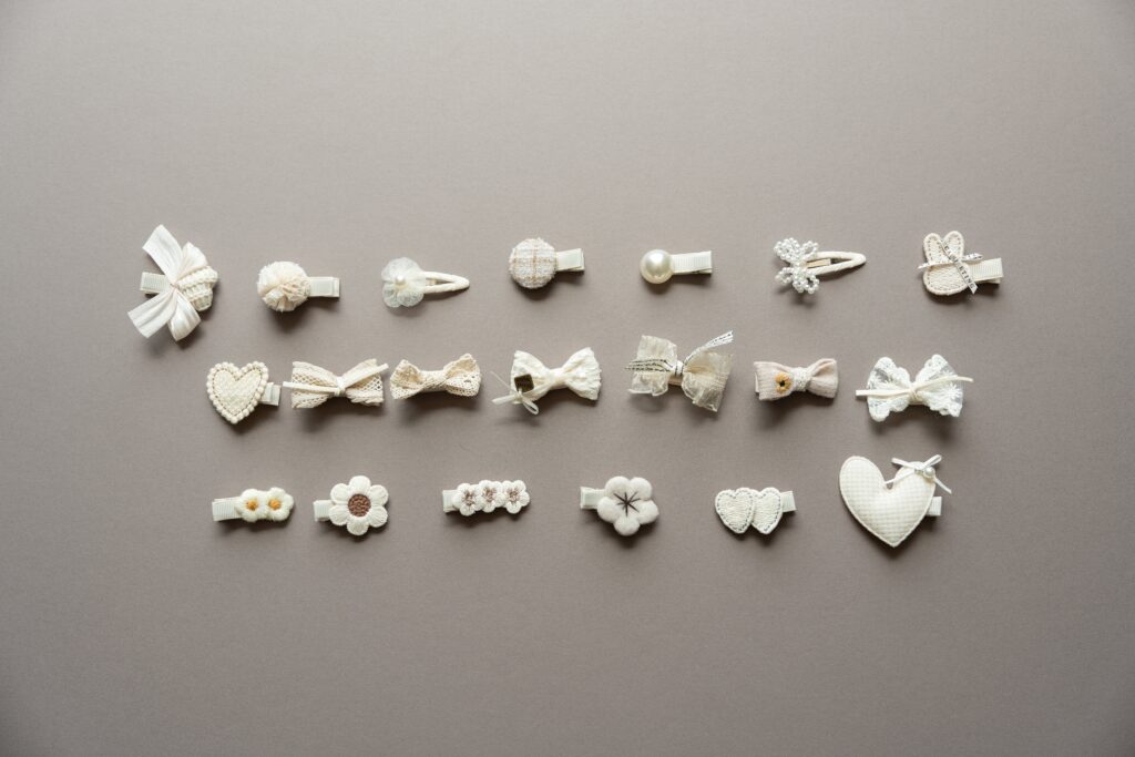 Hair clips lined in three rows on a grey background.