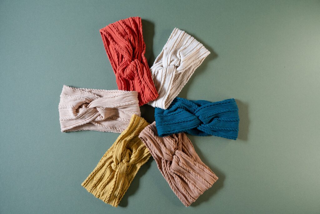 Headbands in different colors on a green background.
