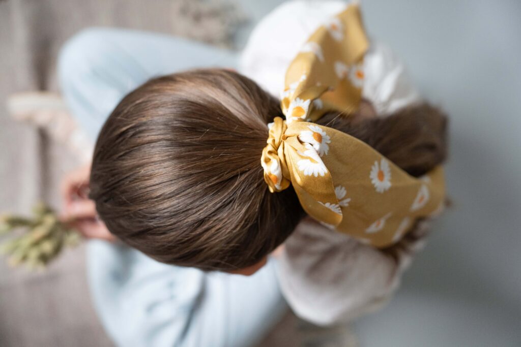 Yellow scrunchie in girls hair! In blog about make product photos scroll-stopping.