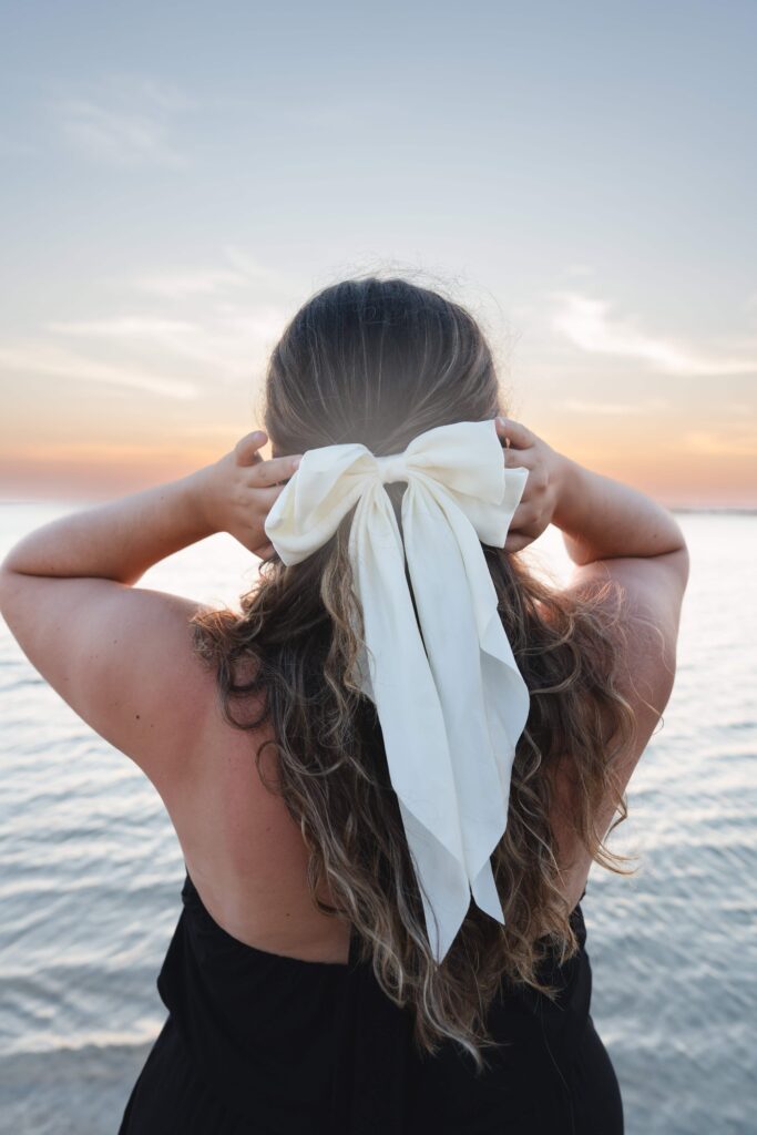 Hair accessory brand photography girl with white bow in her hair.