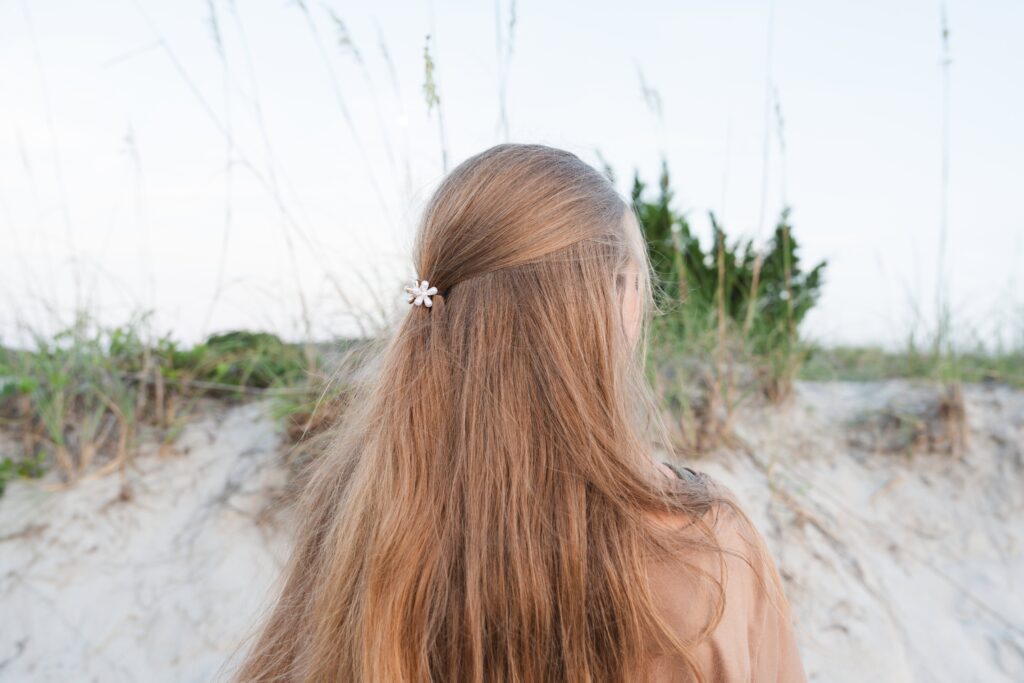 White flower clip in girls hair. How to use brand photos.