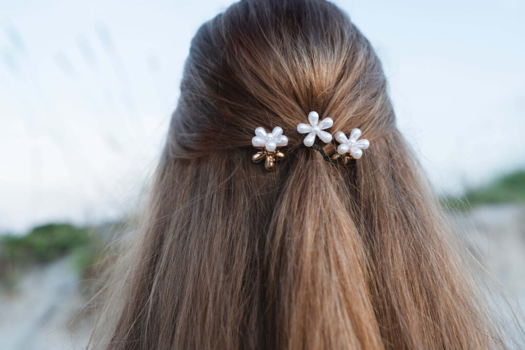 Three white clips in blond hair. 