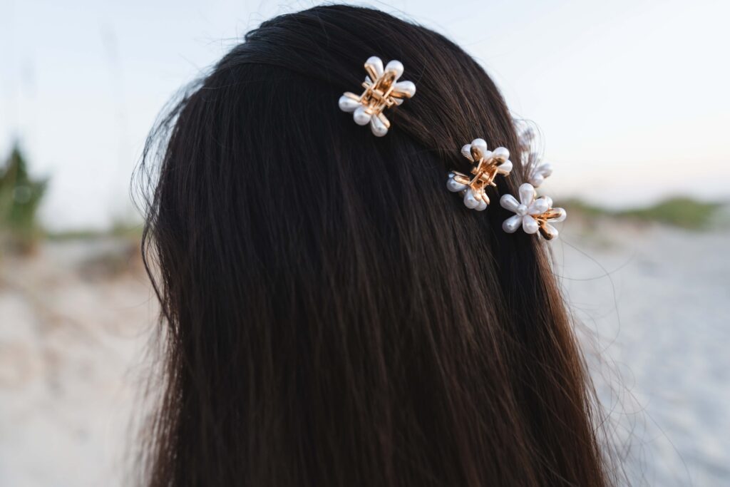 Girl with white flower clips in her hair.